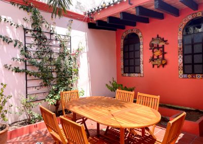 Private patio with garden and dining area for 6 people in Mazatlan vacation home.