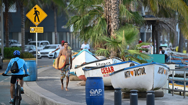 Fishermen in Mazatlan bring their boats up onto the boardwalk as a storm rolls in.